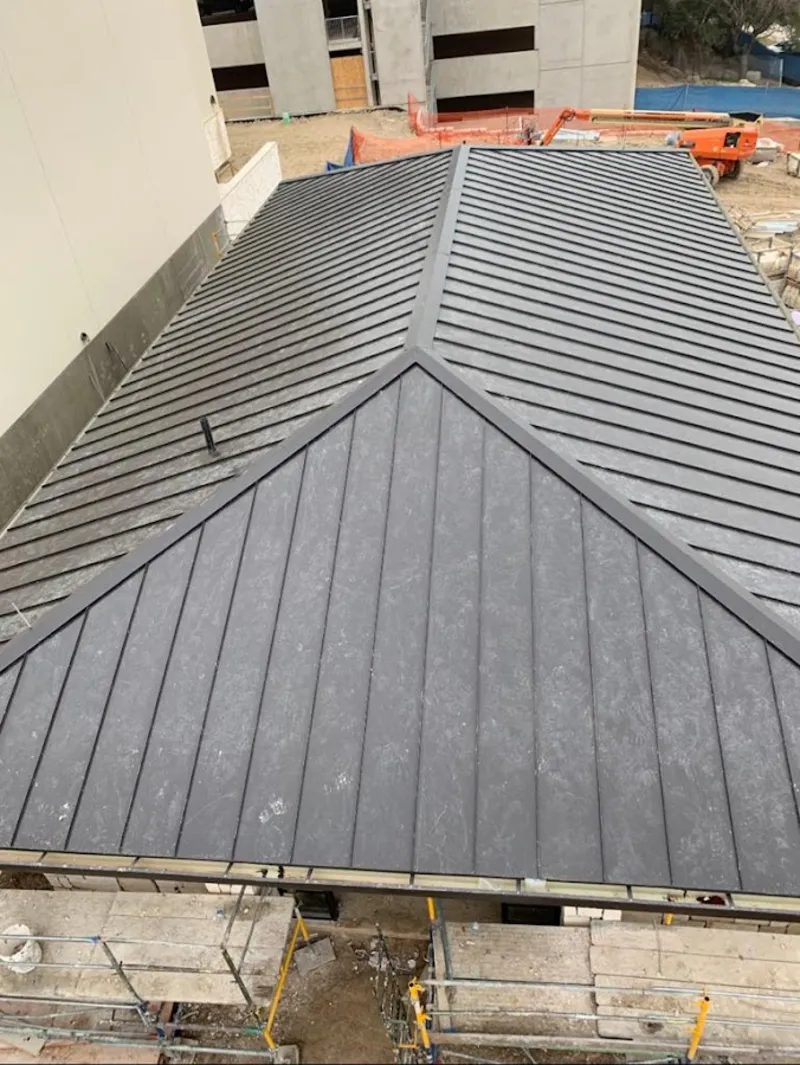 Commercial metal roof construction with crane equipment in Appleton