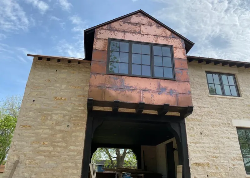Copper metal panel facade on a stone building for Skylight Installation in Appleton